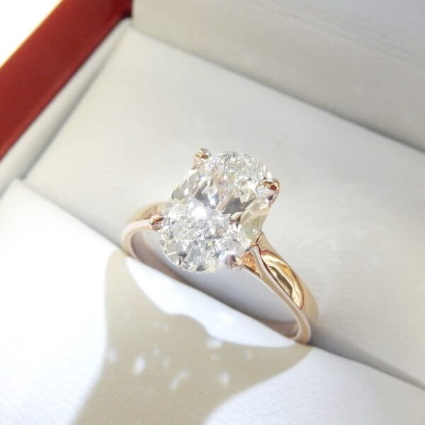 Oval diamond rose gold solitaire