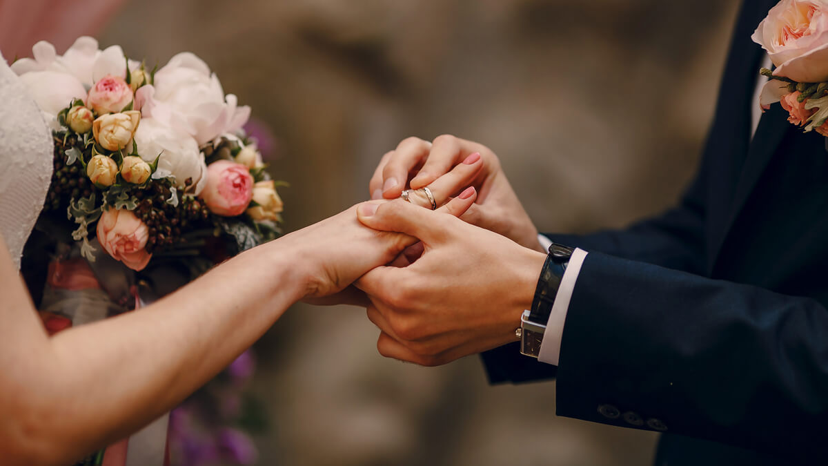 A Couple's Hands with Wedding Rings · Free Stock Photo