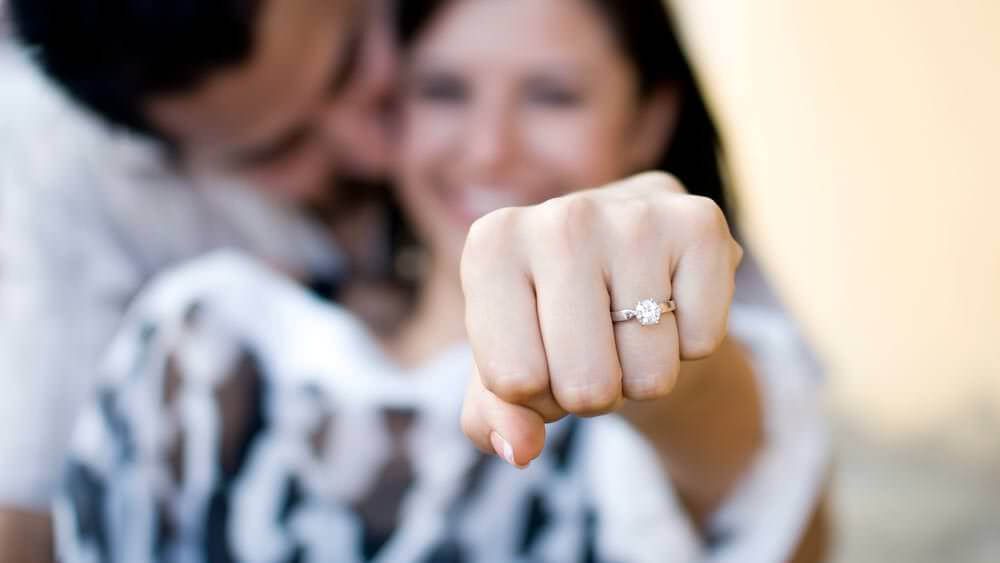 a woman shows her engagement ring