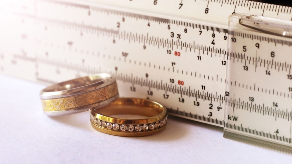 Gold ring with diamonds and a measuring instrument the value of jewelry