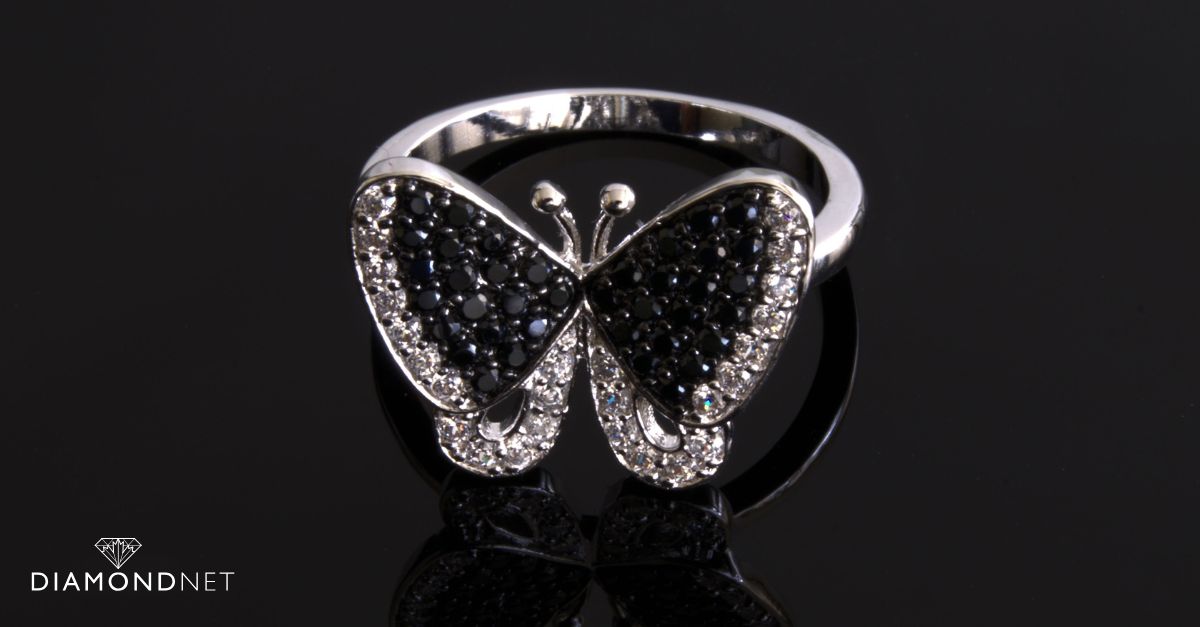 A woman's hand with a butterfly ring, representing butterfly ring symbolism