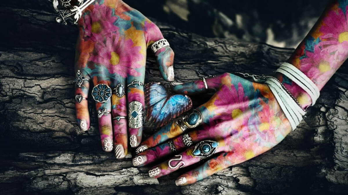 Woman colorful hands with the butterfly jewelry