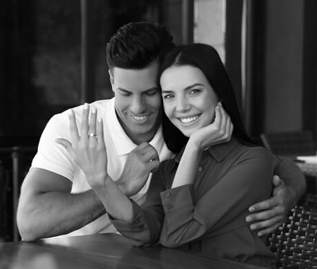 Sweet couple showing their engagement rings Sweet couple showing their engagement rings