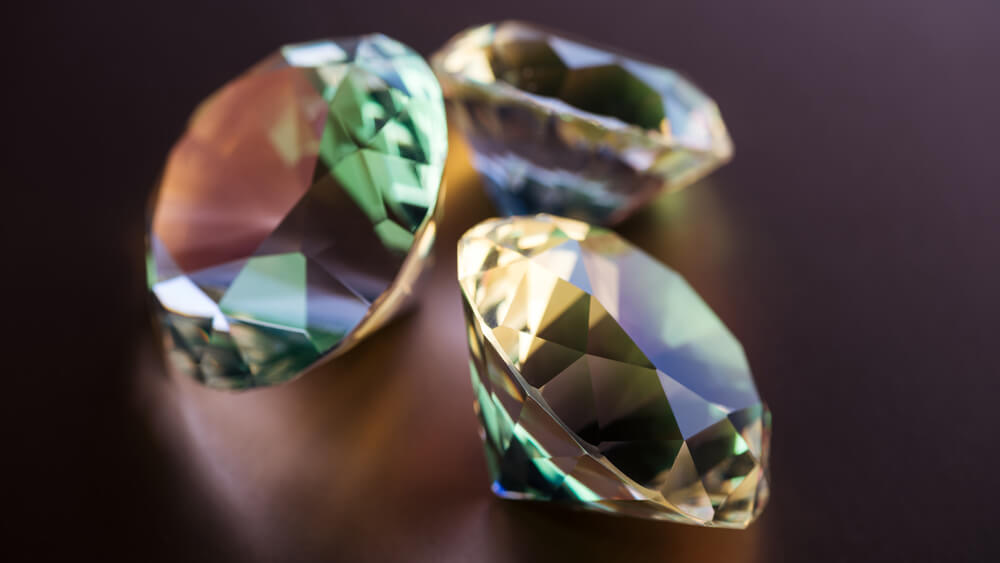 Collection of shiny big diamonds on brown background