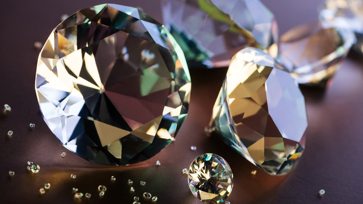 Close-up of big and small diamonds on the brown background