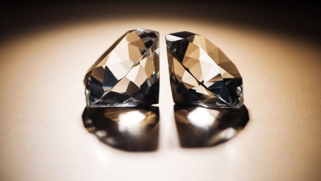Two clear big diamonds on black and golden background