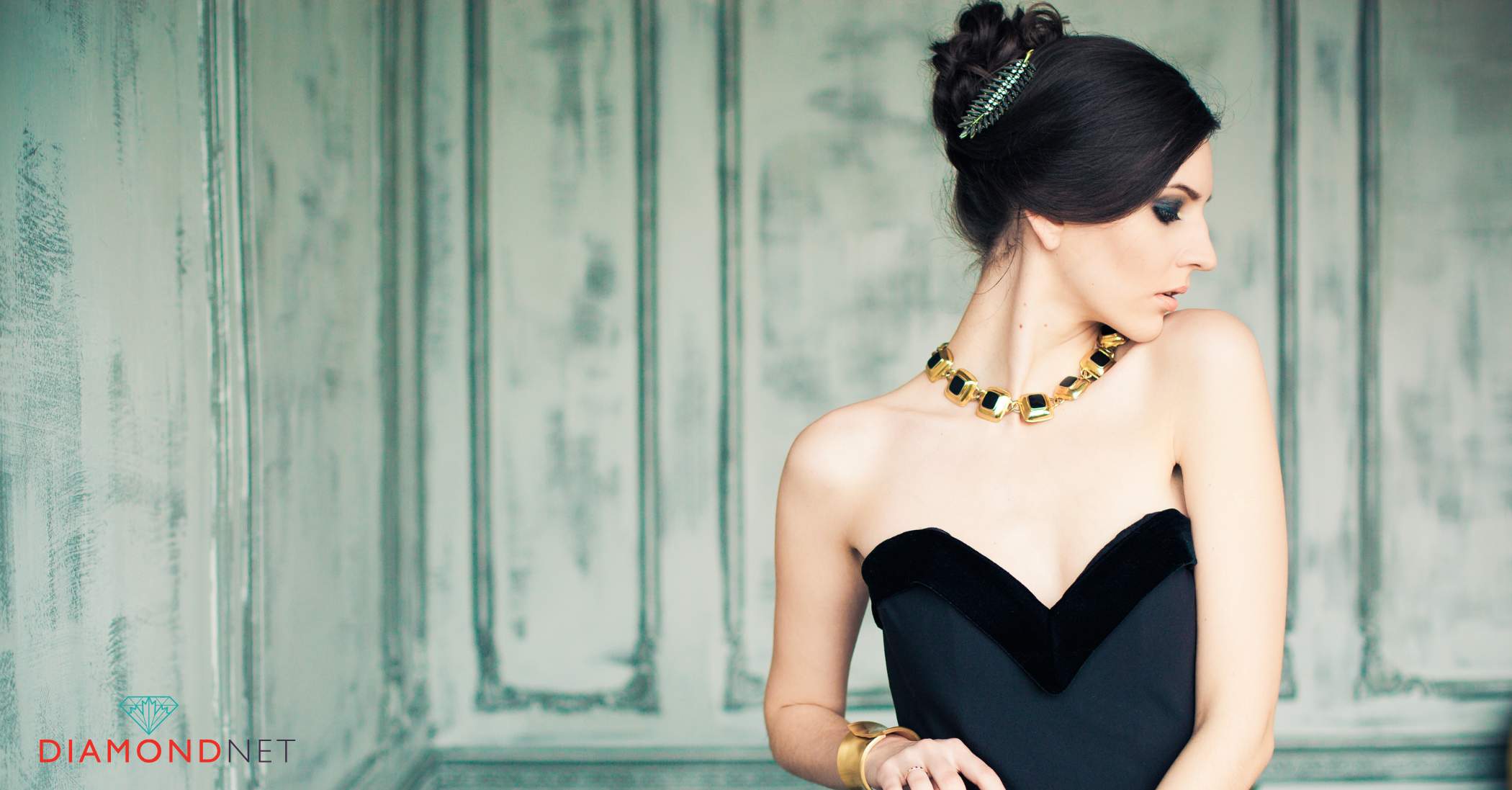 A woman dressed in a outfit complemented by a gold bracelet, highlighting the elegant match of gold colours.