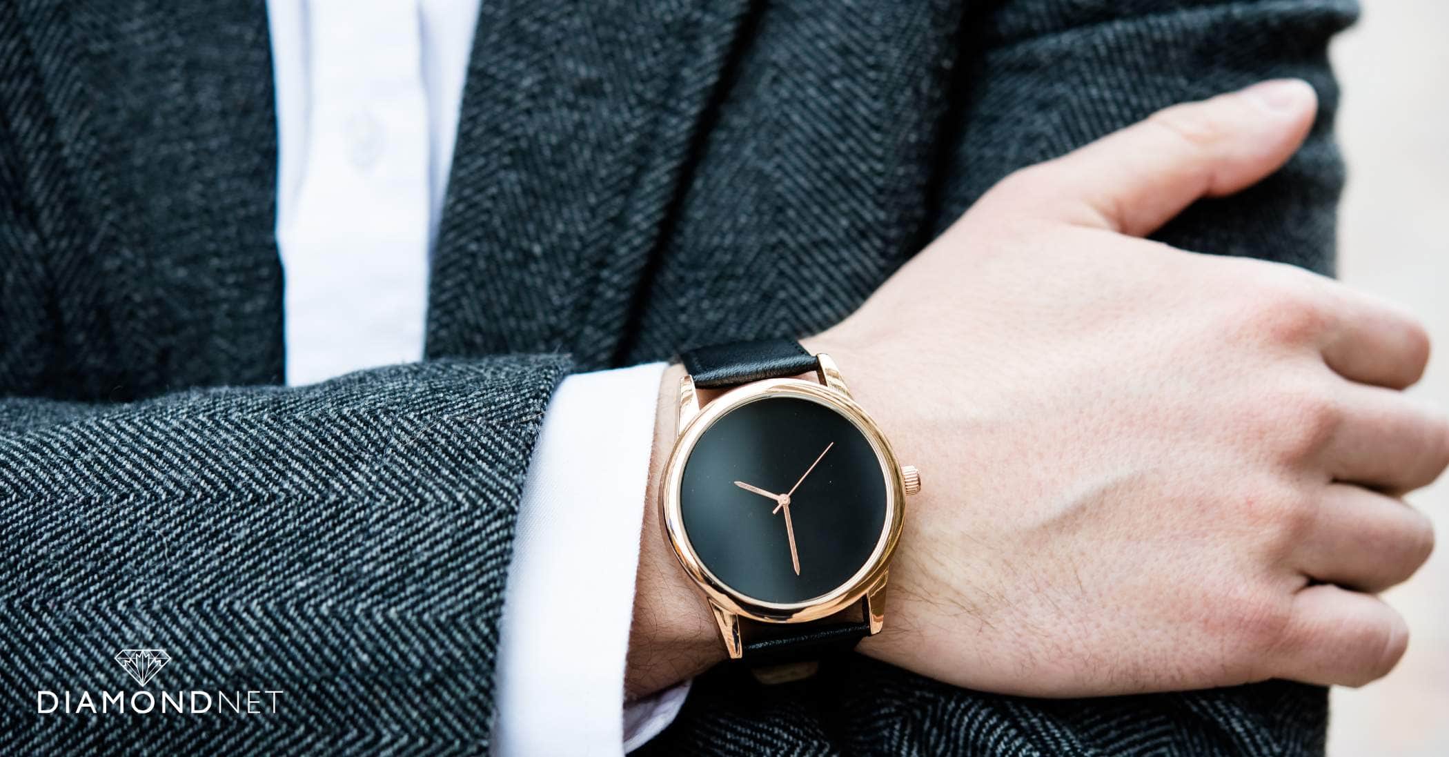 A man elegantly showcasing a dress watch on his wrist