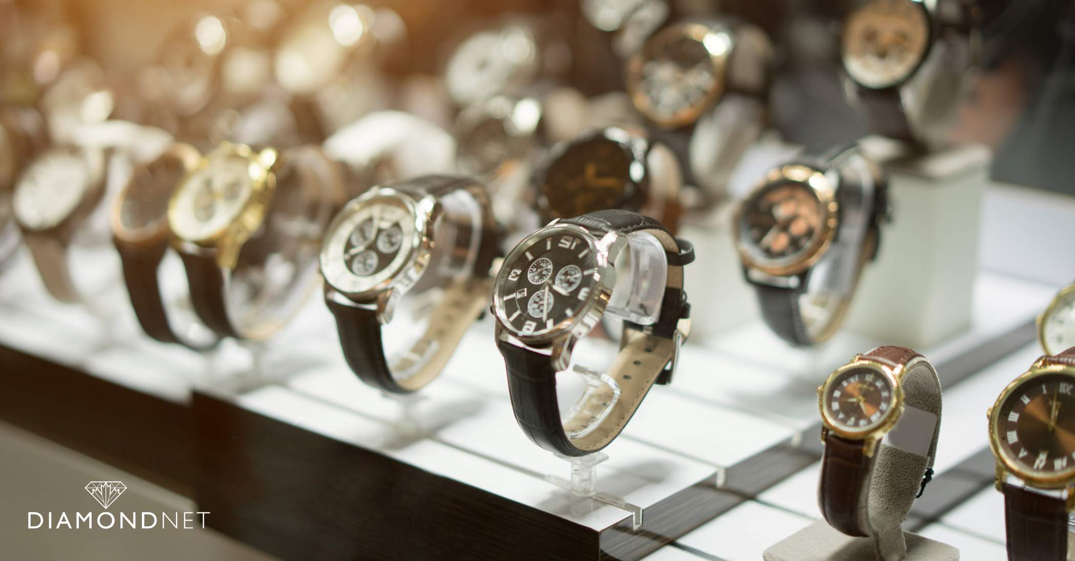  An individual holds a watch, contemplating their choice amid a selection of watches