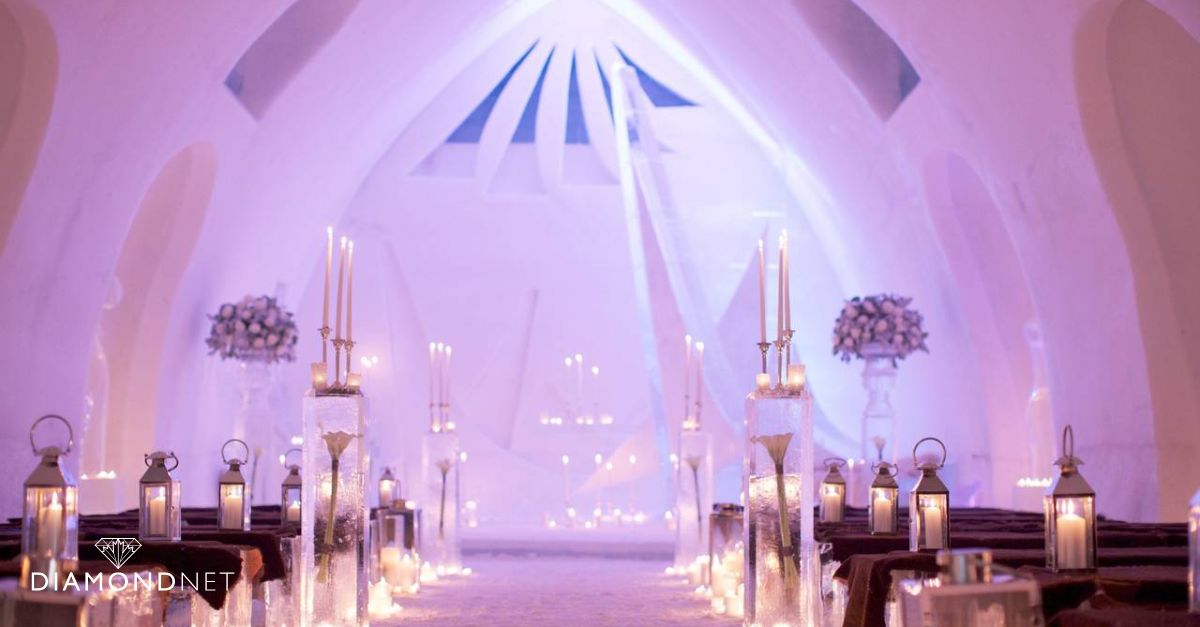 A bride and groom pose at the Hôtel de Glace wedding venue.