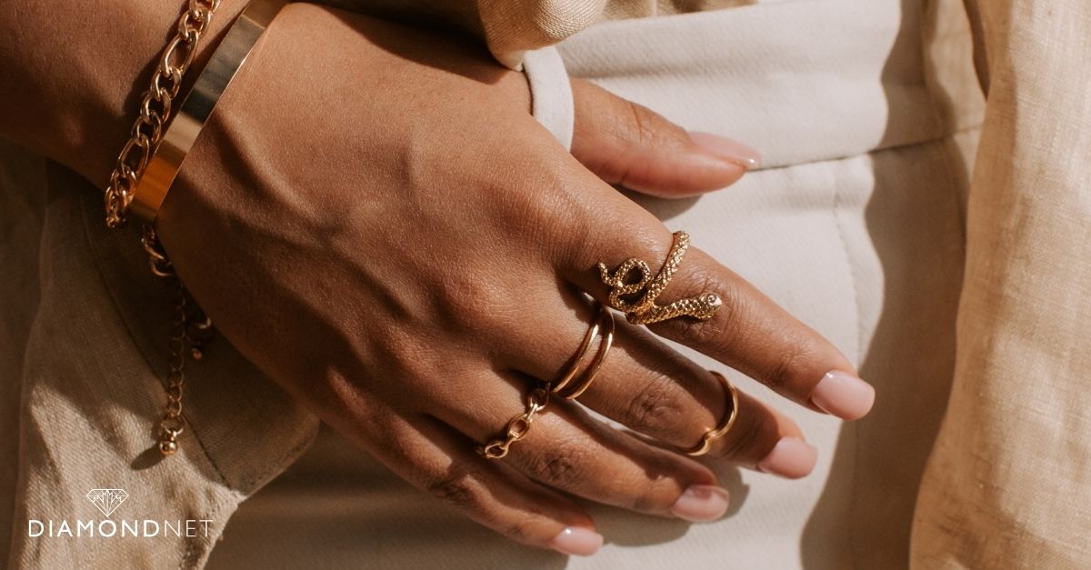 A woman's hand adorned with rings, designed to prevent spinning in the ring stack.