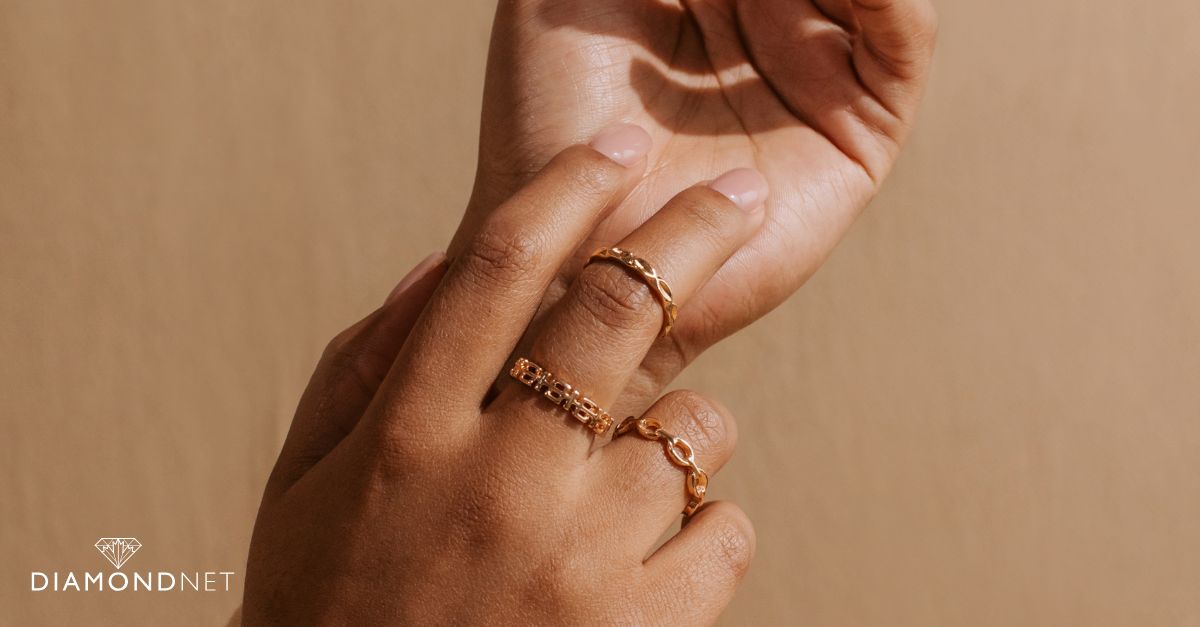 A woman presents an elegant stack of rings, designed to improve the shape of her fingers.