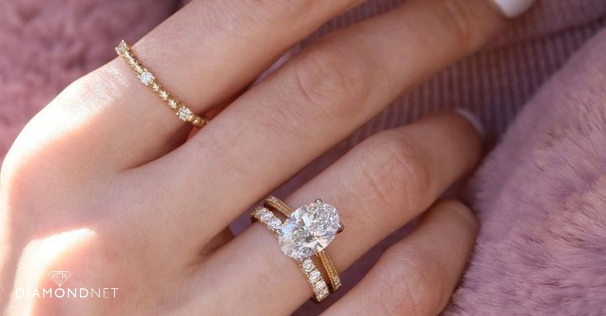 A woman's hand featuring an array of stacked rings