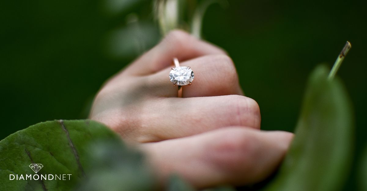 A person holding a diamond in their hand, demonstrating an at-home diamond testing method