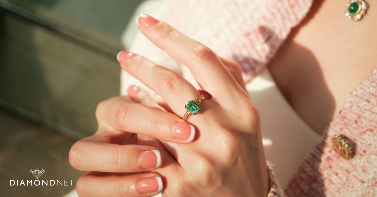 A close-up of a woman's hand displaying a blue sapphire ring, representing a unique non-diamond engagement option