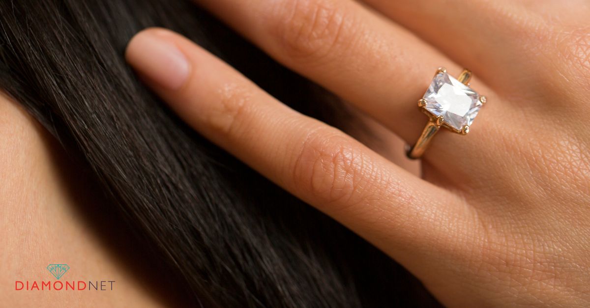 Close-up of a woman's hand adorned with a modern engagement ring