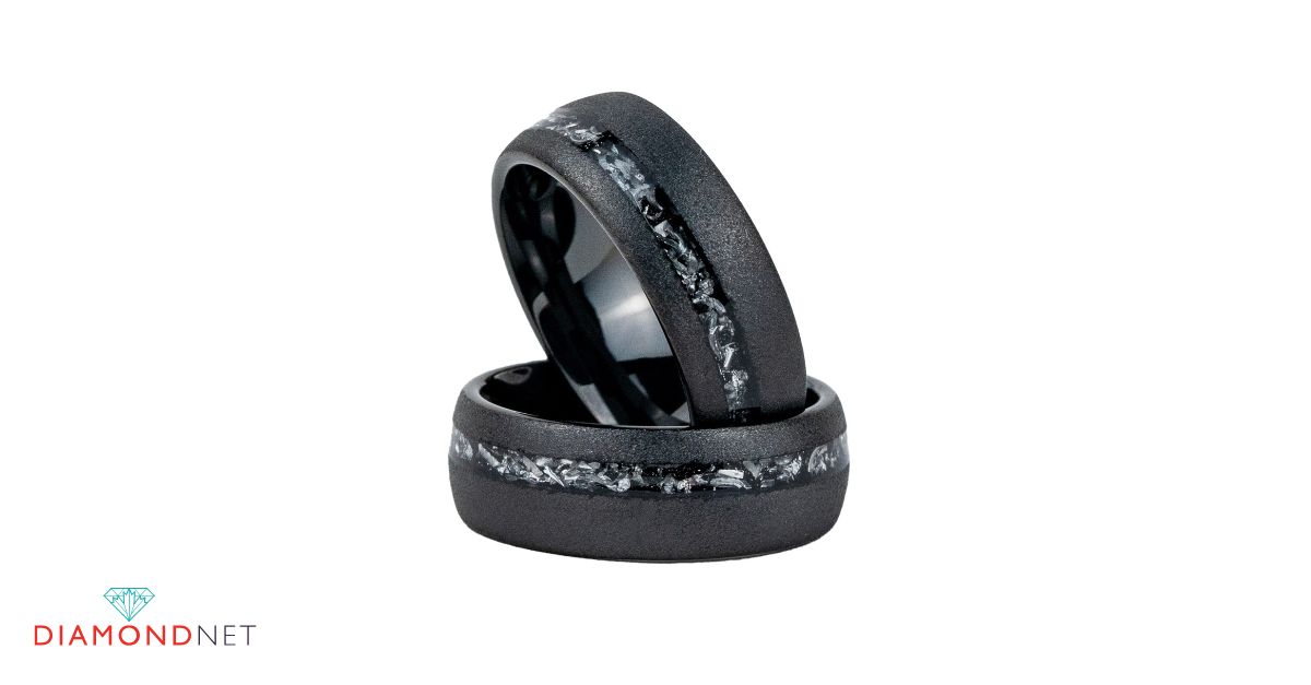 Couple discussing black wedding rings in a jewelry store