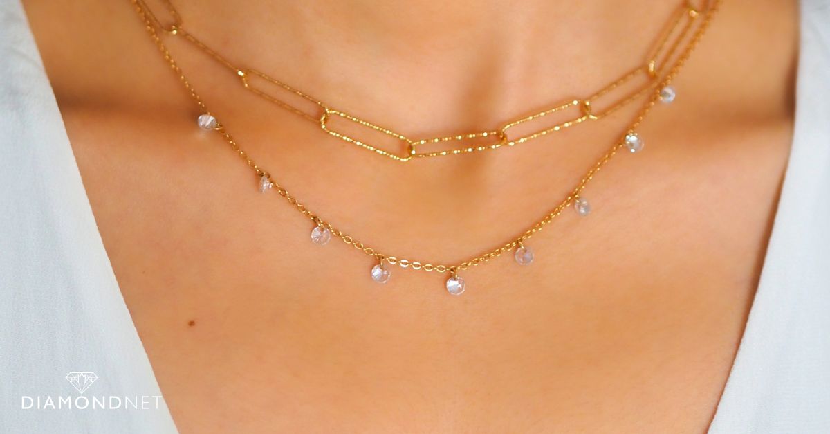 A gold station necklace with evenly spaced diamonds
